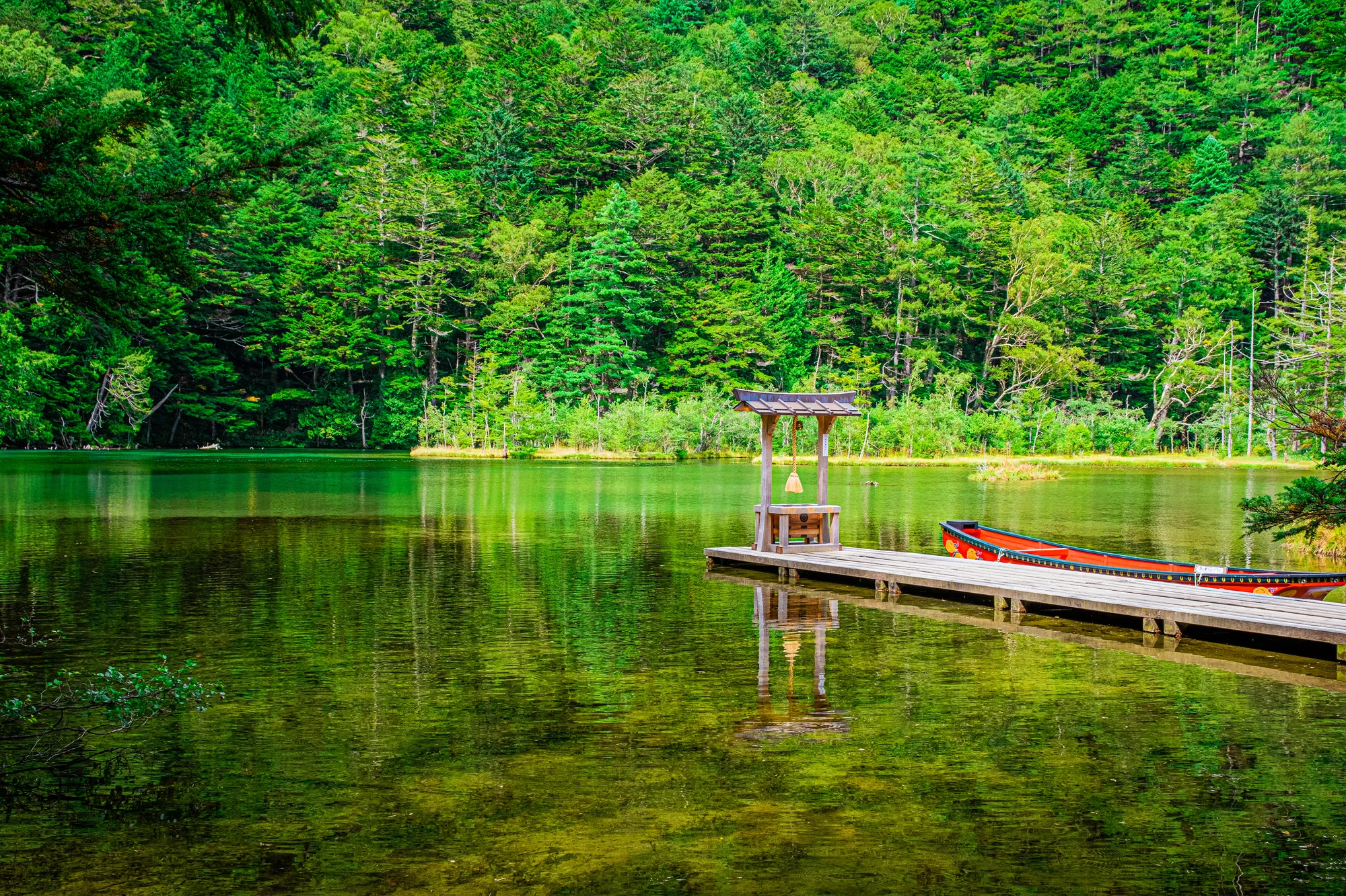Is Okinawa a suitable beach destination for a day trip from Tokyo in July?